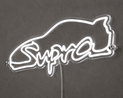 Angled close-up of Supra script neon sign glowing white