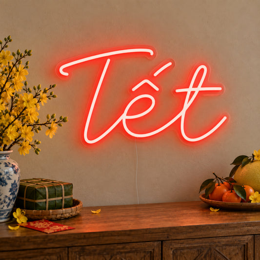 Tết Neon Sign on clear cut-to-shape acrylic, illuminated on a wall in a styled celebration setting