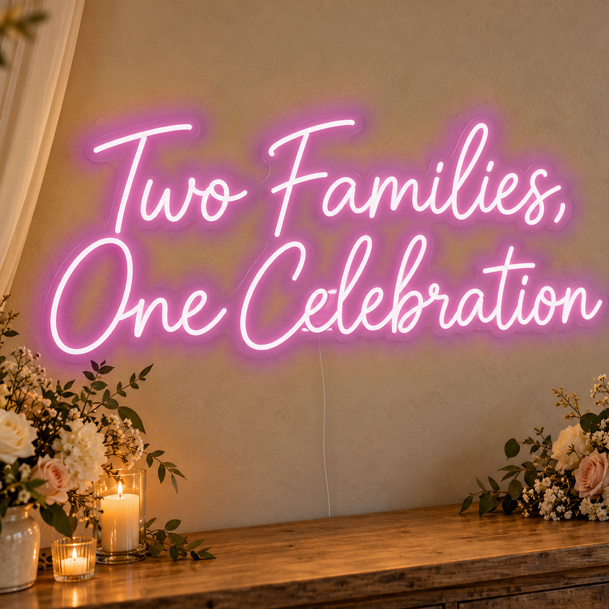 Two Families One Celebration Neon Sign in pink LED neon on clear acrylic, angled view